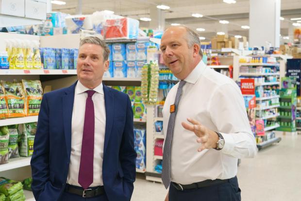 The National: Starmer with Sainsbury's Chief Executive Officer Simon Roberts (right) during a visit to Sainsbury's at Nine Elms, south London