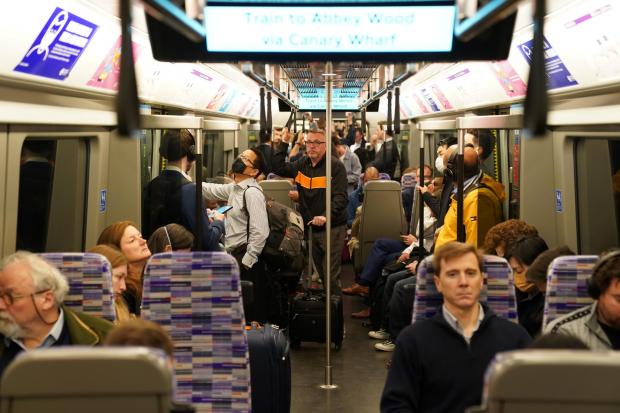The National: Passengers on board an Elizabeth Line train in London, as the new line opens to passengers for the first time. The delayed and overbudget line will boost capacity and cut journey times for east-west travel across London
