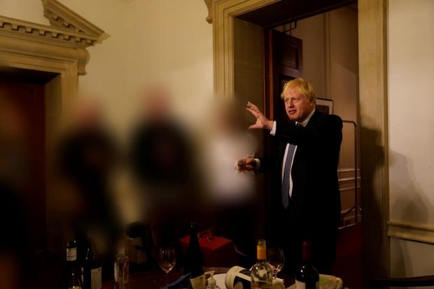The National: Photographs of Johnson surrounded by bottles of booze were included in the report
