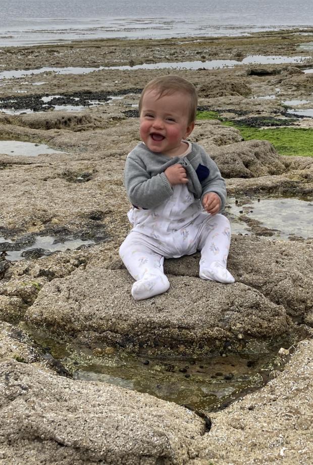 The National: Baby Anthony on a dinosaur's footprint 