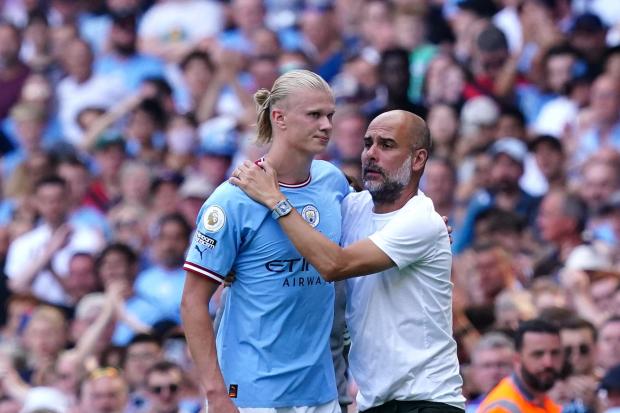 Manchester City manager Pep Guardiola greets Erling Haaland