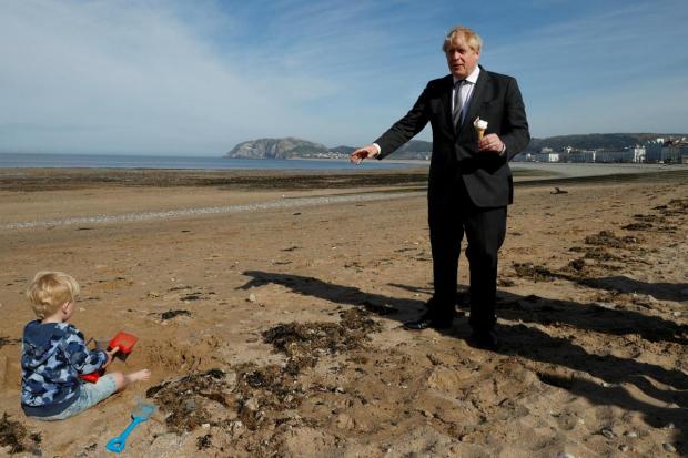 File photo of Boris Johnson on the beach. (PA)