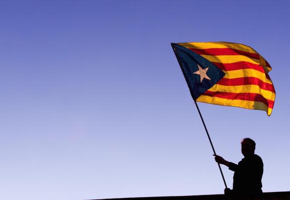 The National: BARCELONA, SPAIN - NOVEMBER 11: A man waves a Catalan Independence flag, know as 'Estelada', on a roof of a building during a demonstration on November 11, 2017 in Barcelona, Spain. Independence movement associations and political parties called The National: BARCELONA, SPAIN - NOVEMBER 11: A man waves a Catalan Independence flag, know as 'Estelada', on a roof of a building during a demonstration on November 11, 2017 in Barcelona, Spain. Independence movement associations and political parties called