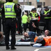 Extinction Rebellion protesters lie down in the road as part of their disruptive protest tactics
