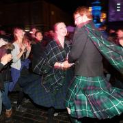 People ceilidh dance on the Royal Mile during the Hogmanay New Year celebrations in Edinburgh