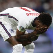 Marcus Rashford reacts after failing to score during England's penalty shoot-out with Italy. He and teammates Jadon Sancho and Bukayo Saka were racially abused afterwards.