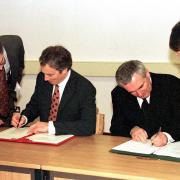 Former UK prime minister, Tony Blair, left, and Irish Taoiseach Bertie Ahern, right, signing The Northern Ireland Peace Agreement