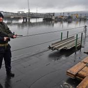 Royal Navy security personnel stand guard on HMS Vigilant at Her Majesty's Naval Base, Clyde