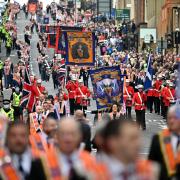 An Orange Order march that would have passed two Catholic churches has been re-routed 'voluntarily' by organisers