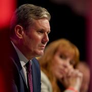 Labour leader Sir Keir Starmer and Labour deputy leader Angela Rayner listen as shadow chancellor Rachel Reeves gives her keynote speech at the Labour Party conference