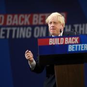 MANCHESTER, ENGLAND - OCTOBER 06: Britain's Prime Minister Boris Johnson delivers his leader's keynote speech during the Conservative Party conference at Manchester Central Convention Complex on October 6, 2021 in Manchester, England. This