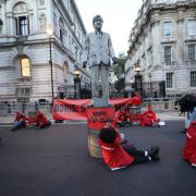 Greenpeace activists locked themselves to the oil-splattered statue of Boris Johnson outside of Downing Street, London. ©Suzanne Plunkett/Greenpeace
