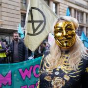 Climate activists stage a 'Trillion Dollar Bash' outside the offices of JP Morgan on Waterloo Street, Glasgow