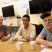 Belgian minister Meryame Kitir with Housing First service users Gary, Craig and Fraser.