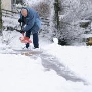 A man clears the snow in Leadhills, South Lanarkshire as Storm Barra hit Scotland with disruptive winds, heavy rain and snow. Photo: PA