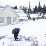 A man clears the snow in Leadhills, South Lanarkshire as Storm Barra hits the UK and Ireland with disruptive winds, heavy rain and snow