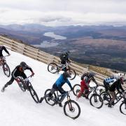 Mountain bikers race down snowy Scottish peak in 'Macavalanche' event