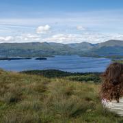 A girl looks out over Loch Lomond and the Trossachs, one of Scotland's two national parks. Photo: Gary Ellis on Unsplash
