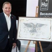 Former Swedish Prime Minister Stefan Lövfen with his newly purchased artwork