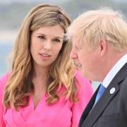 Boris Johnson and Carrie Johnson wait to greet guests for the leaders official welcome and family photo, during the G7 summit in Cornwall