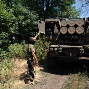 Kuzia, the commander of the unit, shows the rockets on HIMARS vehicle in Eastern Ukraine