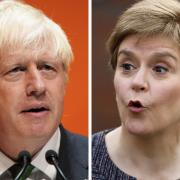 The First Minister, right, has written to Boris Johnson, left, over the cost of living crisis and called for an emergency meeting