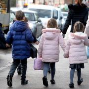 Parents walking their children to school. Picture: PA