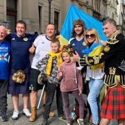 Olena Chernysh from Kharkiv with her two children and some visiting Scotland fans