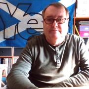 SNP councillor Kenny MacLaren displayed a Yes flag behind him during a full council meeting, much to the dismay of opposition members
