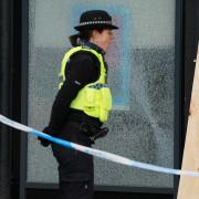 Two men have been arrested after climate activists damaged windows at a Barclays branch in Glasgow