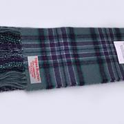 Scarves in purple, green and white tartan are available to buy in the Scottish Parliament gift shop