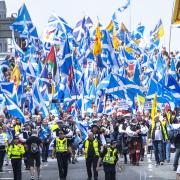 Scottish independence supporters walk through Glasgow during an All Under One Banner march