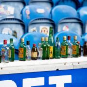 Glass bottles left behind after a Premiership match between Rangers and Celtic at Ibrox Stadium