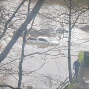 Picture shows car stuck in water at flooded Glasgow park