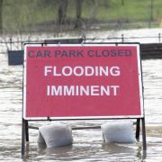 A flood warning sign at the entrance to a flooded car park in Whitesands, Dumfries in December 2022