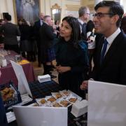 Rishi Sunak and wife Akshata Murty smile as they prepare to sample a traditional haggis toastie for Burns Night