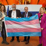 From left to right: Petra Stein, Netherlands MP, Thomas Pringle and Robert Troy, Irish politicians, and Hannah Bardell, SNP MP, holding the trans rights flag at the Council of Europe HQ