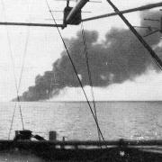 The plume of smoke from the stricken HMS Dasher, taken from one of the nearby ships, HMS Isle of Sark, on March 27, 1943