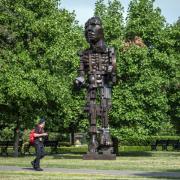A man walks past a sculpture by Eduardo Paolozzi entitled 'Vulcan' in Regent's Park, London