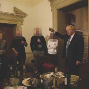 Boris Johnson (right) at a leaving gathering in the vestibule of the Press Office of 10 Downing Street, while Covid rules were in place