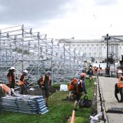 Builders erect seating outside Buckingham Palace in preparation for King Charles's coronation on May 6