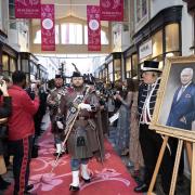 The London Scottish Band march down Burlington Arcade in London, as it unveils a celebratory installation to mark the coronation of King Charles III