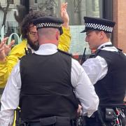 Police in London arrest an anti-monarchy protester during the King's coronation