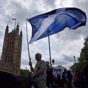 A Scottish Saltire flag flies outside the Houses of Parliament during a photocall of newly-elected Scottish National Party (SNP) members of parliament (MPs) in London in 2015