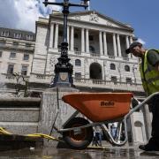 Worker with a wheelbarrow outside the Bank of England in the City of London