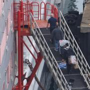 People board the Bibby Stockholm immigration barge moored in Dorset