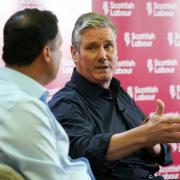 Keir Starmer speaks at a Labour campaign event in Rutherglen as Scottish Labour's Anas Sarwar listens on