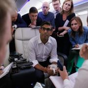 Prime Minister Rishi Sunak holds a 'huddle' press conference with political journalists on board a Government plane as he travels to Delhi