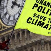 File photograph provided by Greenpeace of climate protesters outside the Houses of Parliament