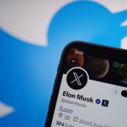 File photograph shows a phone displaying the Twitter account for Elon Musk